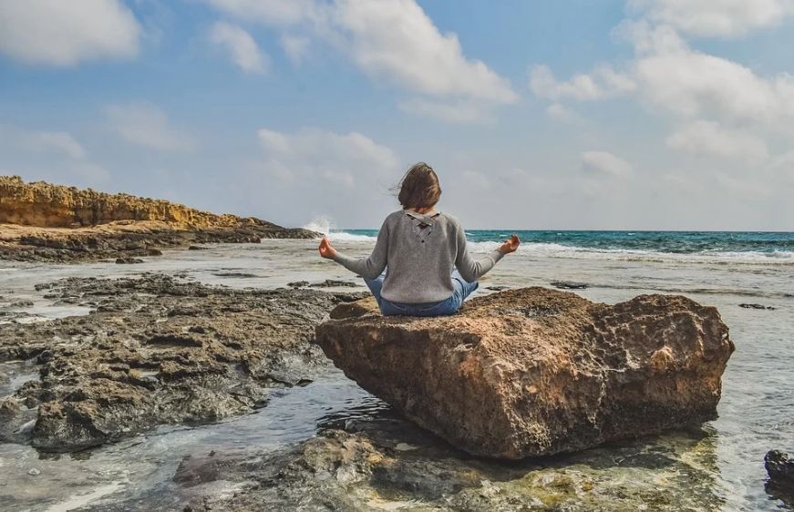 woman meditating outdoors