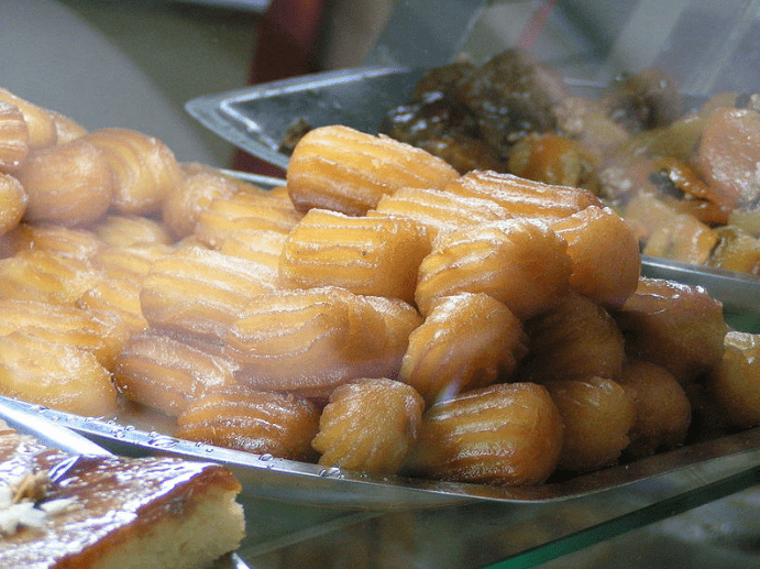 piles of tulumba, fried doughs soaked in syrup