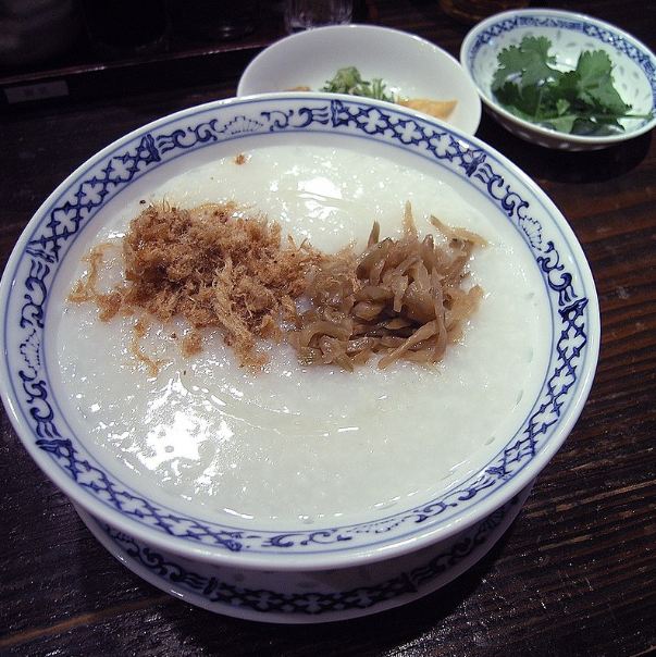 Chinese congee topped with pork floss and pickled vegetables