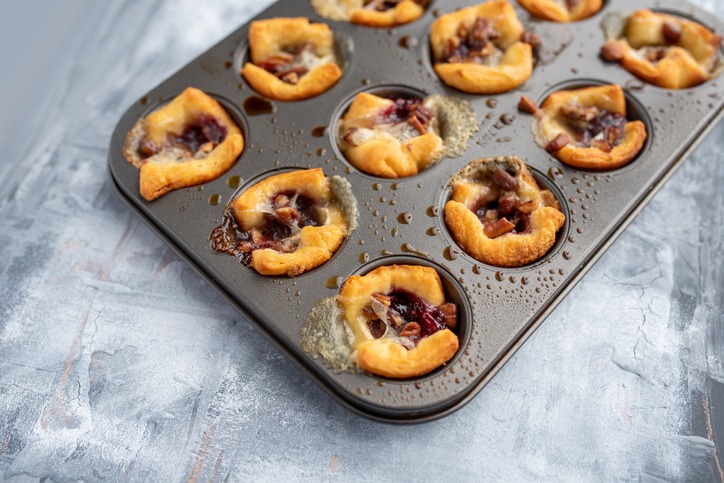 Brie bites with jam and nuts in crescent dough, mini appetizer dessert with cranberry or any jelly