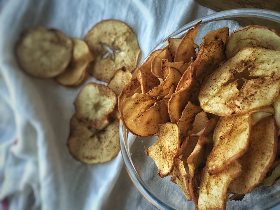 baked apple chips with cinnamon in a bowl