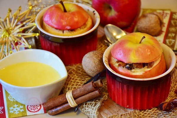Baked apples served with syrup and cinnamon