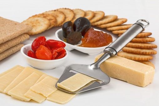 Crackers with some cheese, fruits, and jam