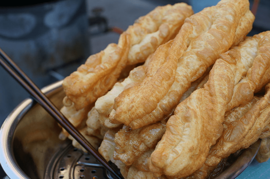 a pile of youtiao, fried doughs