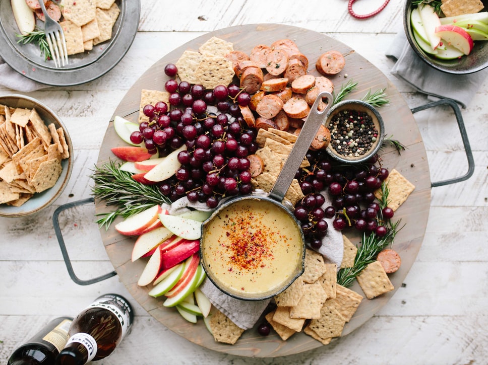 cheese board with fruits, spreads, and more