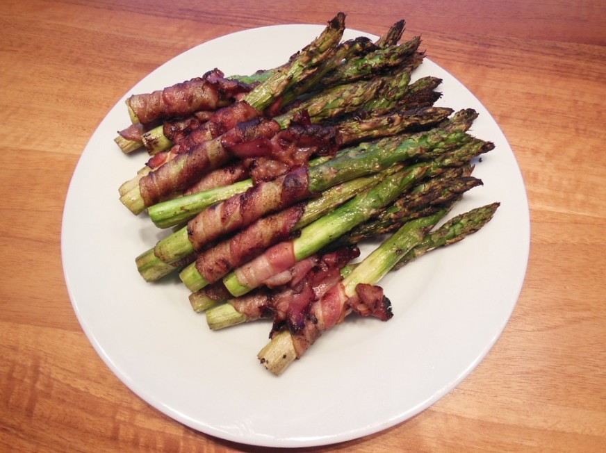 some bacon wrapped asparagus on a plate