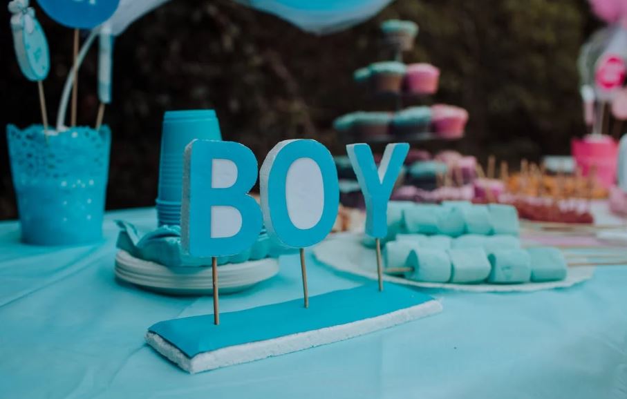 A buffet table with a blue ‘boy’ standing decor