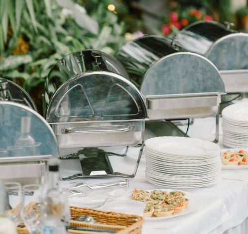 A buffet table with dishware and food